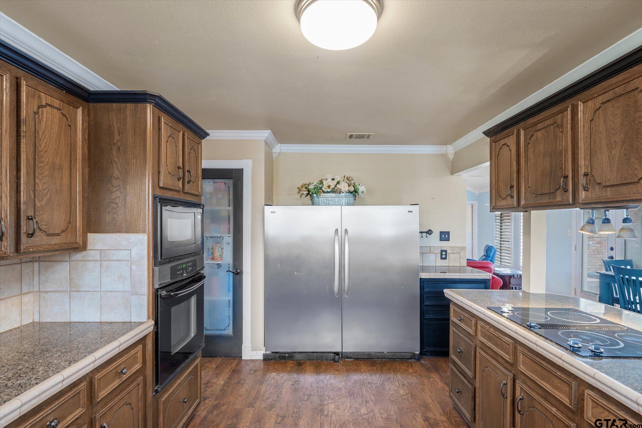 1936 Silver Maple Road Big Sandy, TX 75755 - Photo 15 of 48 a kitchen with stainless steel appliances granite countertop a refrigerator sink and stove