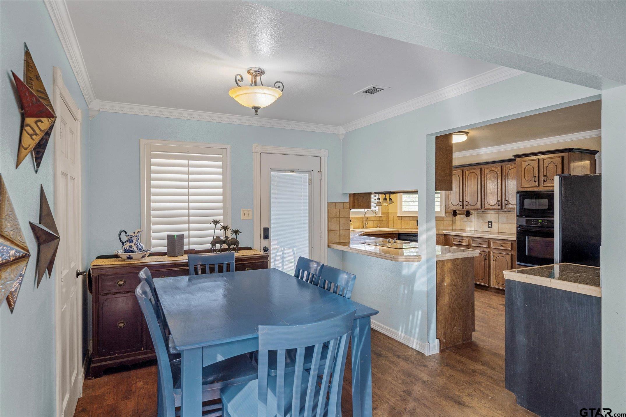 1936 Silver Maple Road Big Sandy, TX 75755 - Photo 16 of 48 a kitchen with a table chairs refrigerator and microwave