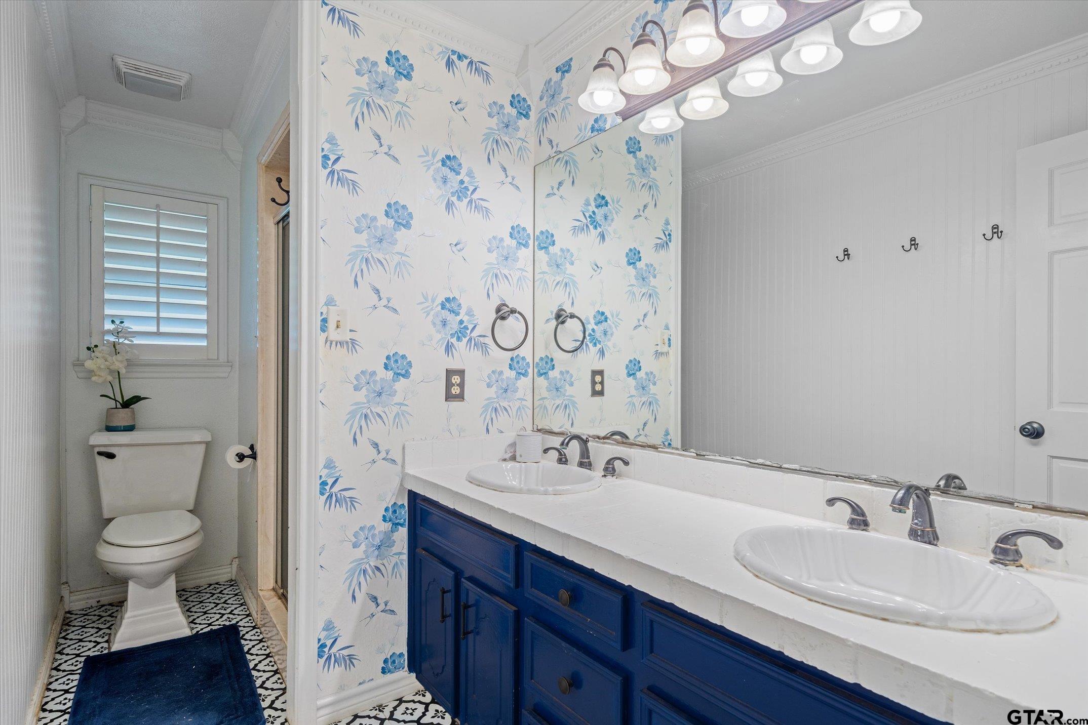 1936 Silver Maple Road Big Sandy, TX 75755 - Photo 23 of 48 a bathroom with a sink a toilet and a large mirror
