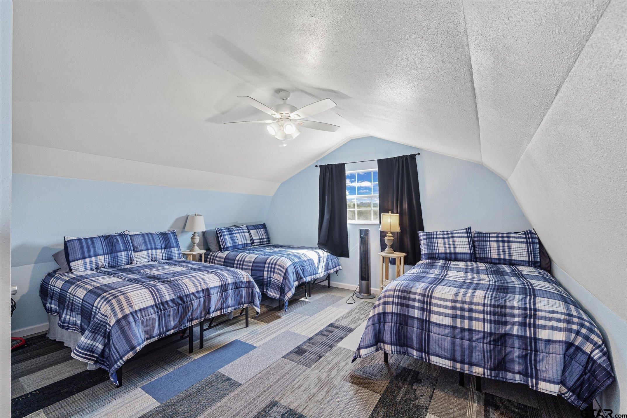 1936 Silver Maple Road Big Sandy, TX 75755 - Photo 39 of 48 a bedroom with two beds and a chandelier