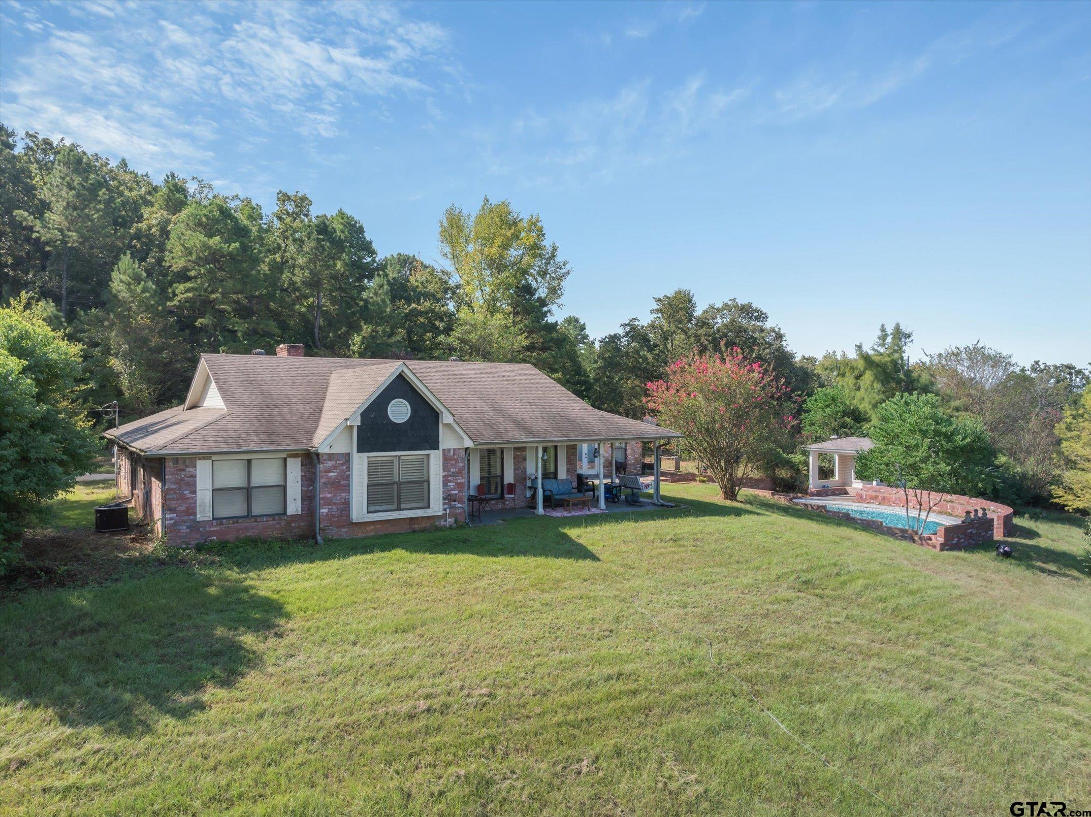 1936 Silver Maple Road Big Sandy, TX 75755 - Photo 4 of 48 a view of a house with swimming pool and a yard