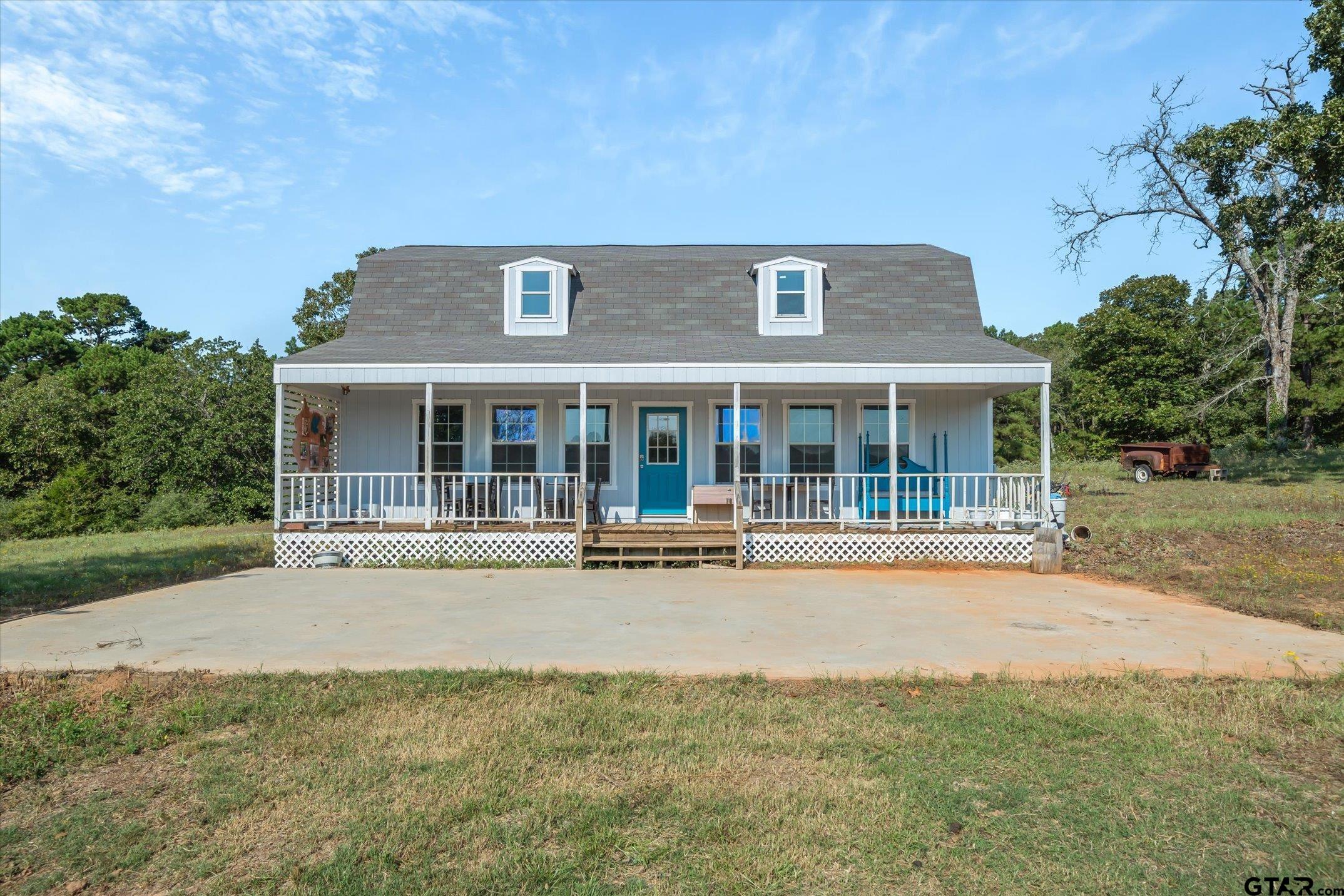 1936 Silver Maple Road Big Sandy, TX 75755 - Photo 41 of 48 front view of a house with a large window and a yard