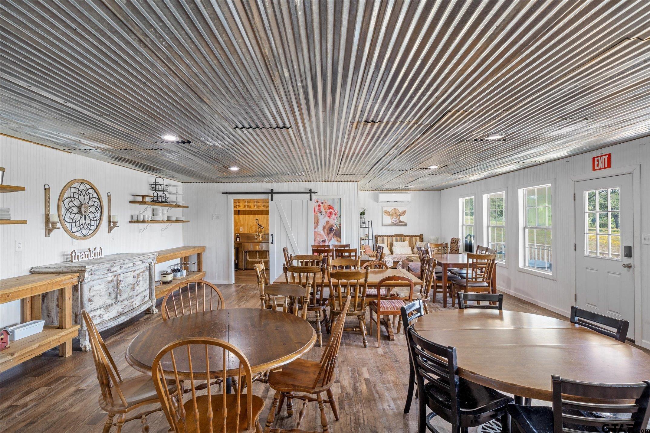 1936 Silver Maple Road Big Sandy, TX 75755 - Photo 42 of 48 a dining hall with stainless steel appliances granite countertop a dining table and chairs with wooden floor