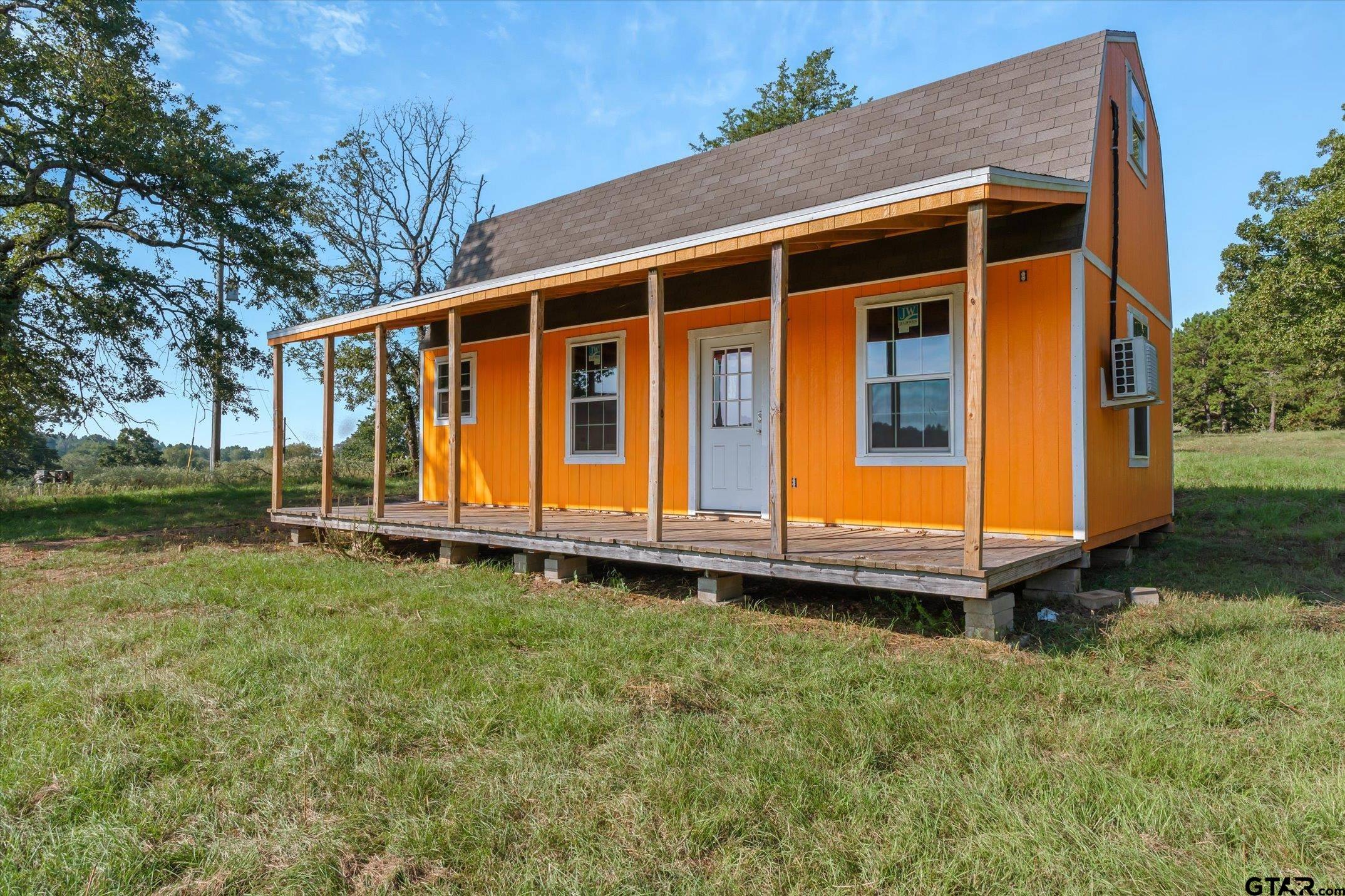 1936 Silver Maple Road Big Sandy, TX 75755 - Photo 44 of 48 a blue swimming pool is sitting in front of a house