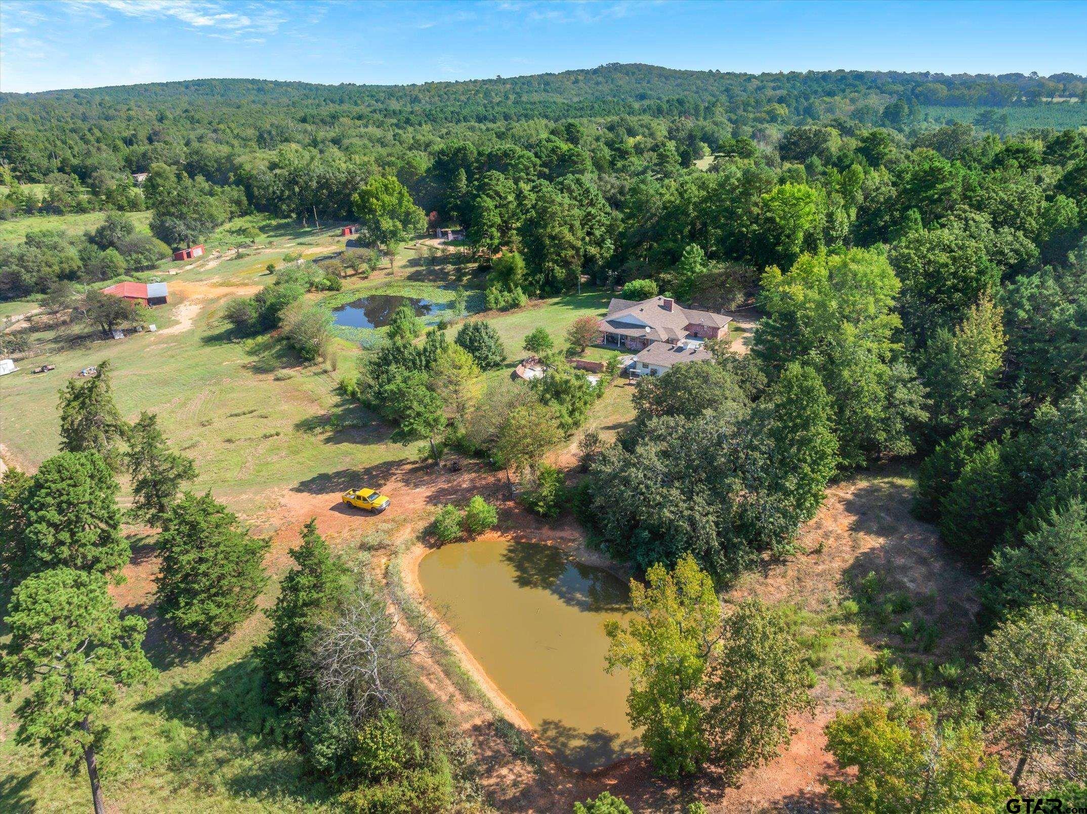 1936 Silver Maple Road Big Sandy, TX 75755 - Photo 9 of 48 an aerial view of residential houses with outdoor space and trees