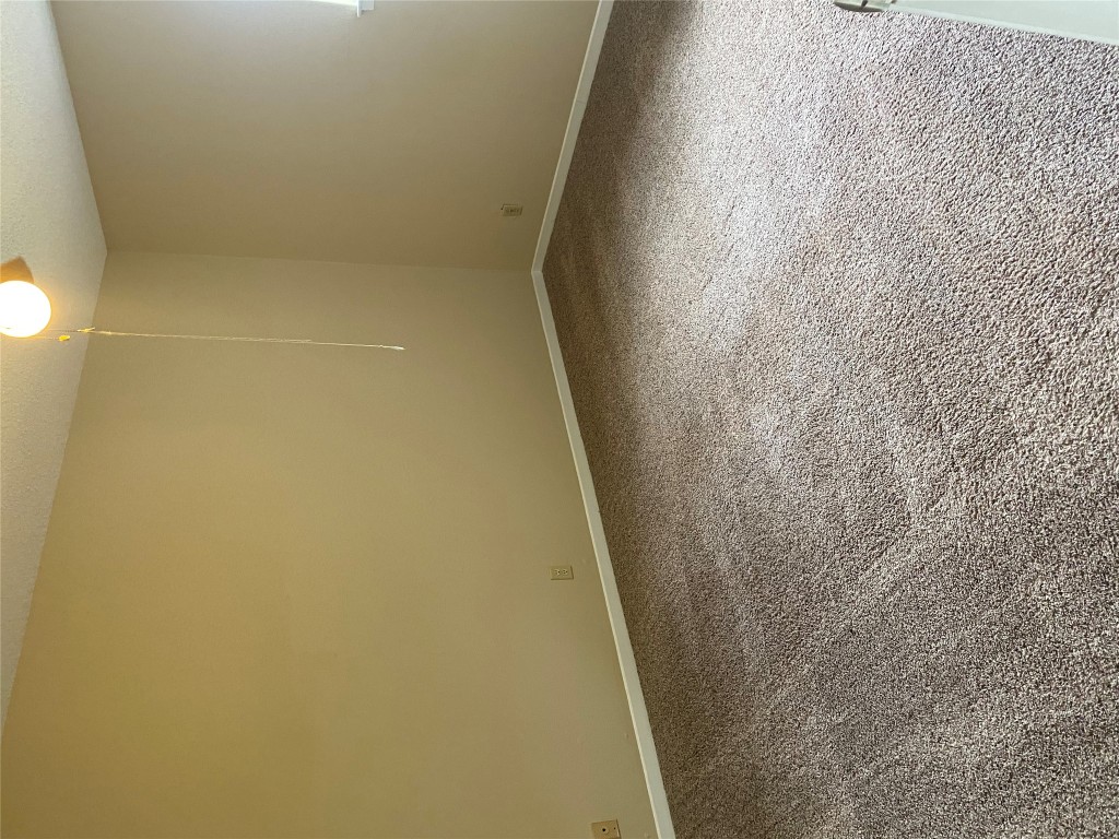 1601 Enfield Road, Unit 5 Austin, TX 78703 - Photo 12 of 20 Unfurnished room featuring carpet and a textured ceiling