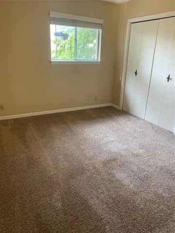 a bathroom with a granite countertop toilet a sink a mirror and bathtub