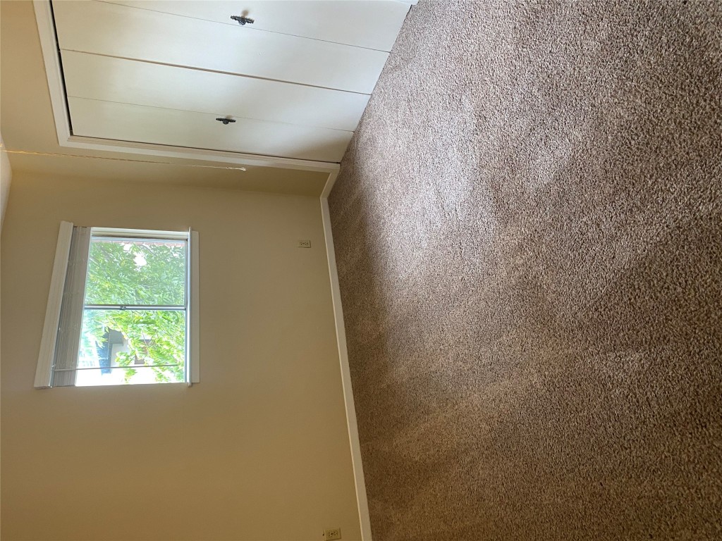 1601 Enfield Road, Unit 5 Austin, TX 78703 - Photo 13 of 20 Unfurnished bedroom featuring carpet and a closet