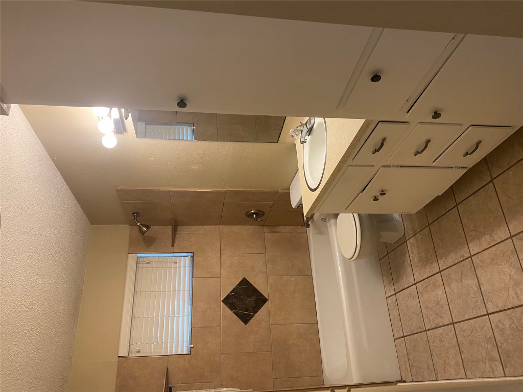 1601 Enfield Road, Unit 5 Austin, TX 78703 - Photo 15 of 20 Bathroom featuring vanity, shower / tub combination, a textured ceiling, and light tile patterned floors