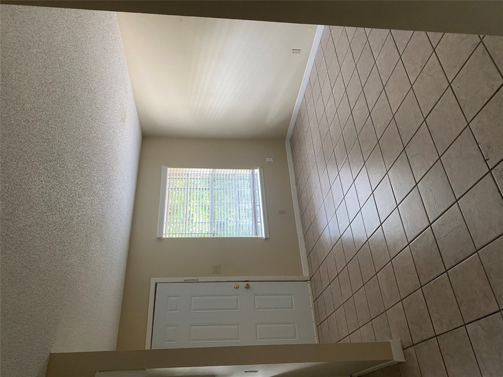 1601 Enfield Road, Unit 5 Austin, TX 78703 - Photo 2 of 20 Unfurnished room with a textured ceiling and light tile patterned flooring