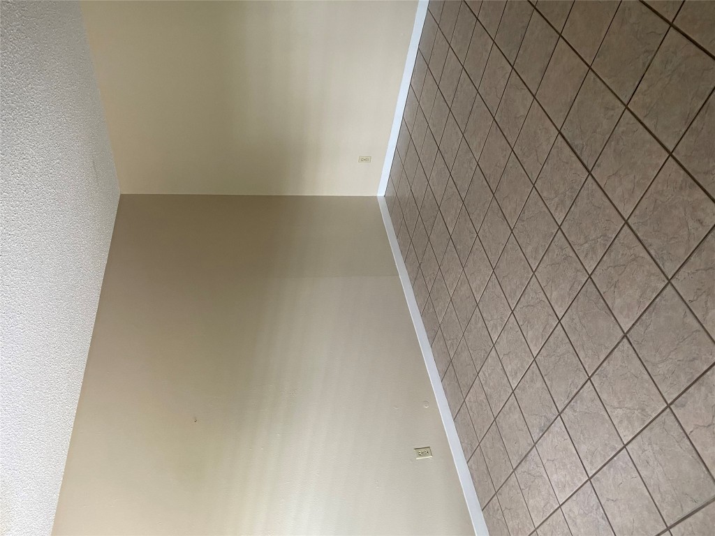1601 Enfield Road, Unit 5 Austin, TX 78703 - Photo 3 of 20 Tiled empty room with a textured ceiling and baseboards