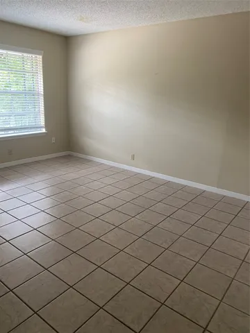 a room with a cabinets and a refrigerator