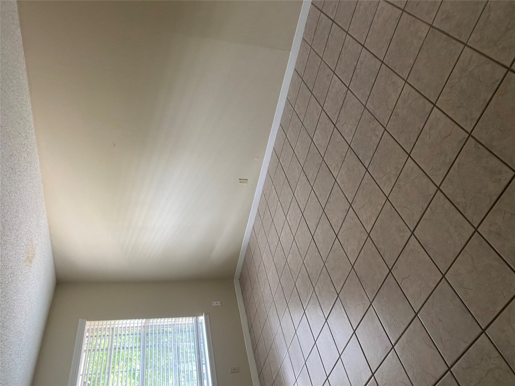 1601 Enfield Road, Unit 5 Austin, TX 78703 - Photo 4 of 20 Empty room featuring a textured ceiling and light tile patterned flooring