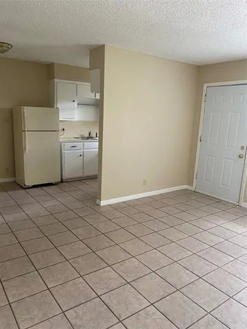 a kitchen with a refrigerator sink washer and dryer
