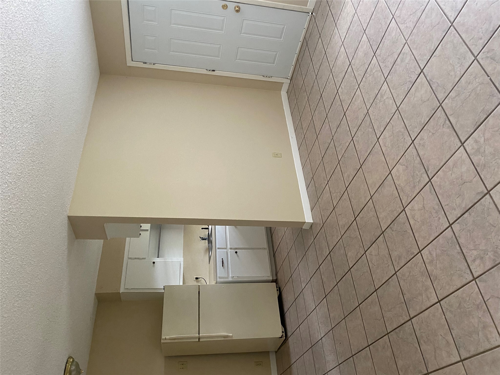 1601 Enfield Road, Unit 5 Austin, TX 78703 - Photo 5 of 20 a room with a cabinets and a refrigerator