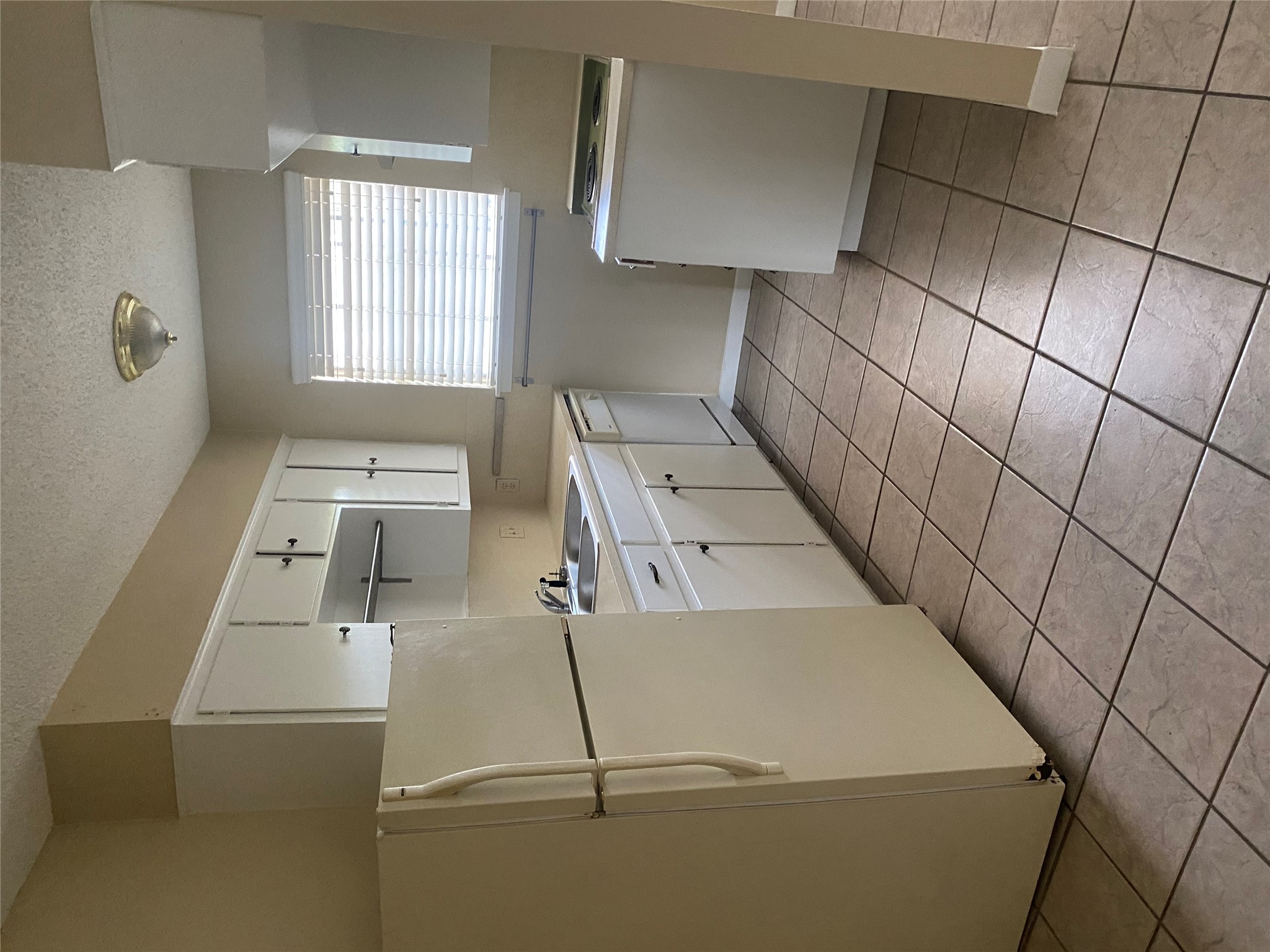 1601 Enfield Road, Unit 5 Austin, TX 78703 - Photo 6 of 20 a kitchen with a refrigerator sink washer and dryer