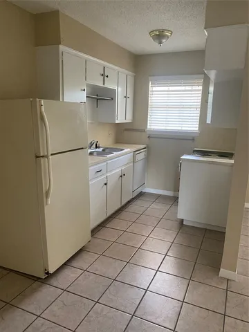 a kitchen with cabinets appliances and a sink