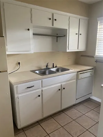 a stove top oven sitting inside of a kitchen