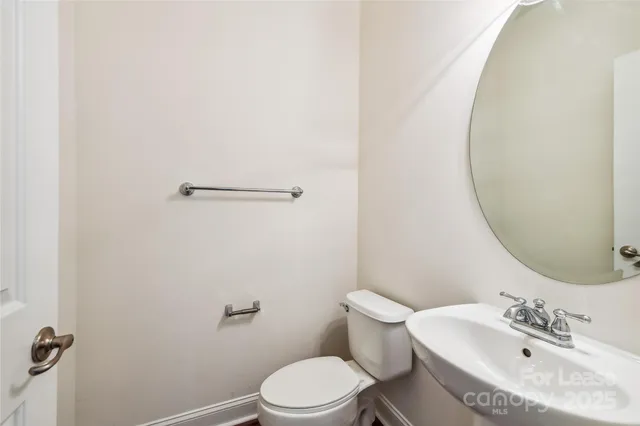 a white toilet sitting next to a bathroom sink