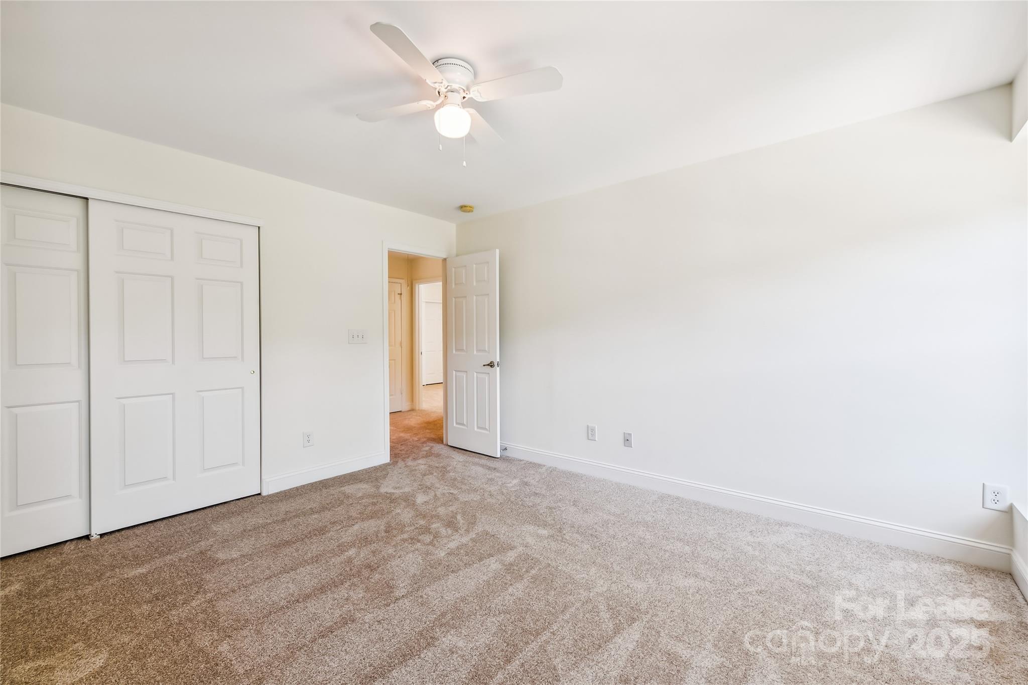 15614 Normans Landing Drive Charlotte, NC 28273 - Photo 17 of 21 an empty room with a ceiling fan and a window