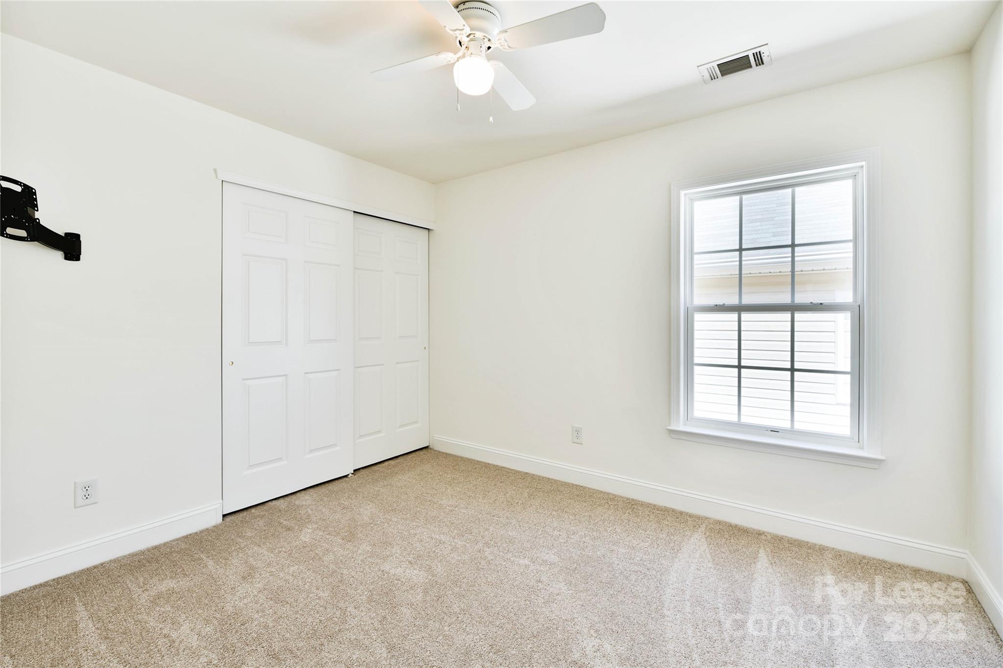 15614 Normans Landing Drive Charlotte, NC 28273 - Photo 18 of 21 an empty room with a window and a fan