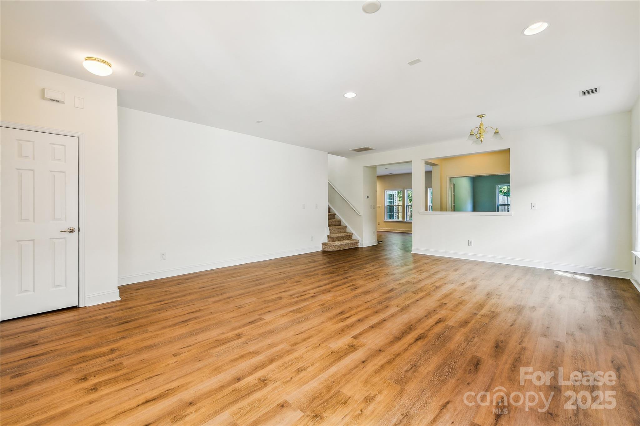 15614 Normans Landing Drive Charlotte, NC 28273 - Photo 2 of 21 an empty room with wooden floor and windows