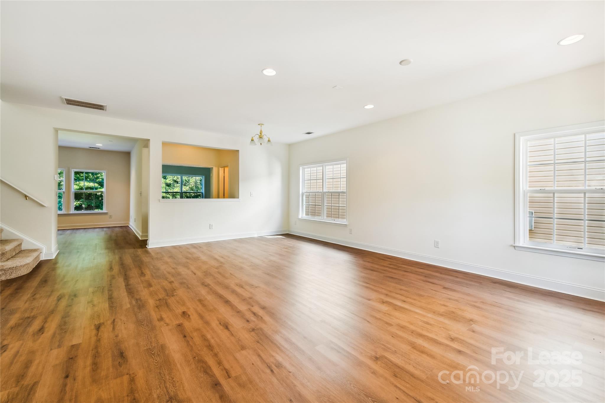 15614 Normans Landing Drive Charlotte, NC 28273 - Photo 3 of 21 an empty room with wooden floor and windows
