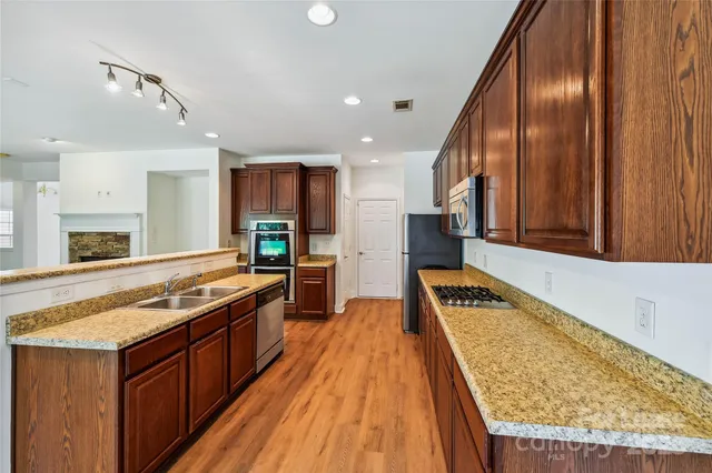 a kitchen with stainless steel appliances granite countertop a stove and a sink