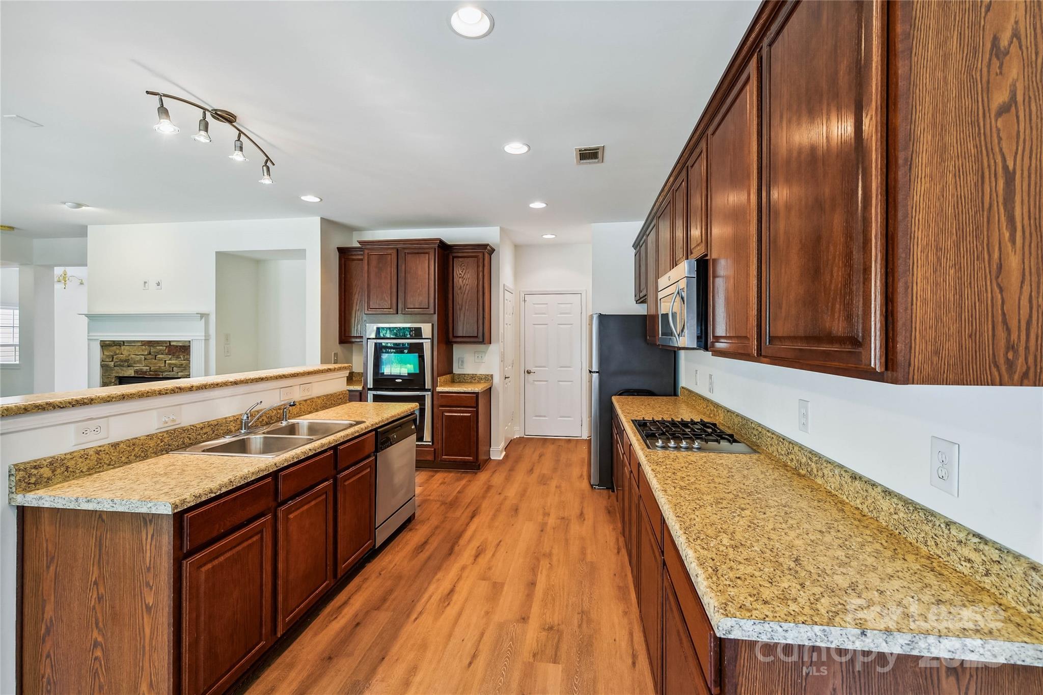 15614 Normans Landing Drive Charlotte, NC 28273 - Photo 8 of 21 a kitchen with stainless steel appliances granite countertop a stove and a sink