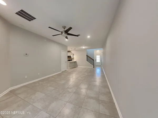 a view of an empty room with a ceiling fan