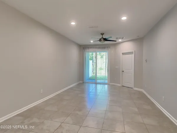 an empty room with windows and closet