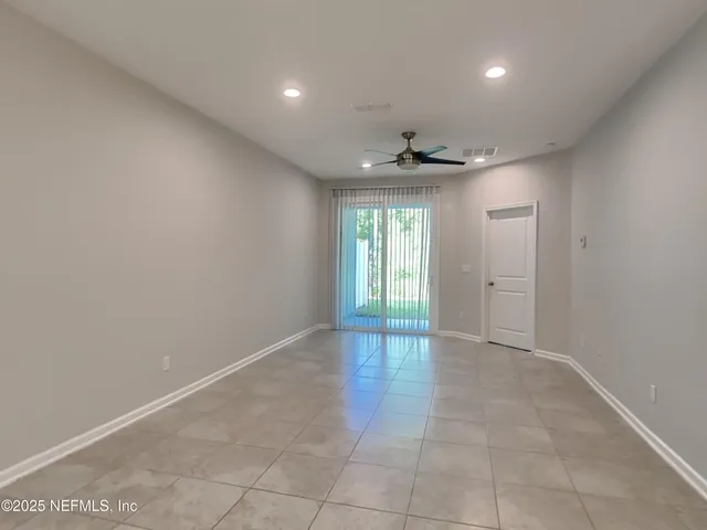 an empty room with windows and closet