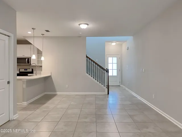 a view of a kitchen with an empty space and a window