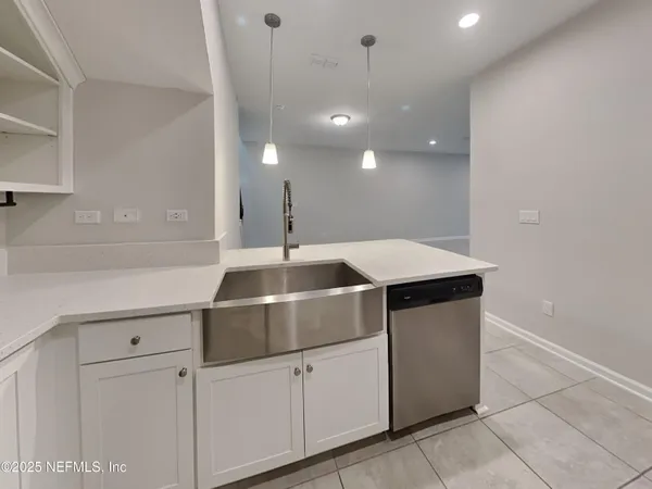 a kitchen with a sink and cabinets