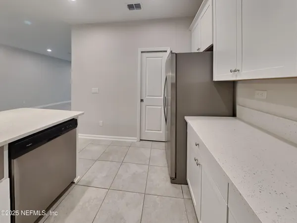 a kitchen with a refrigerator and cabinets