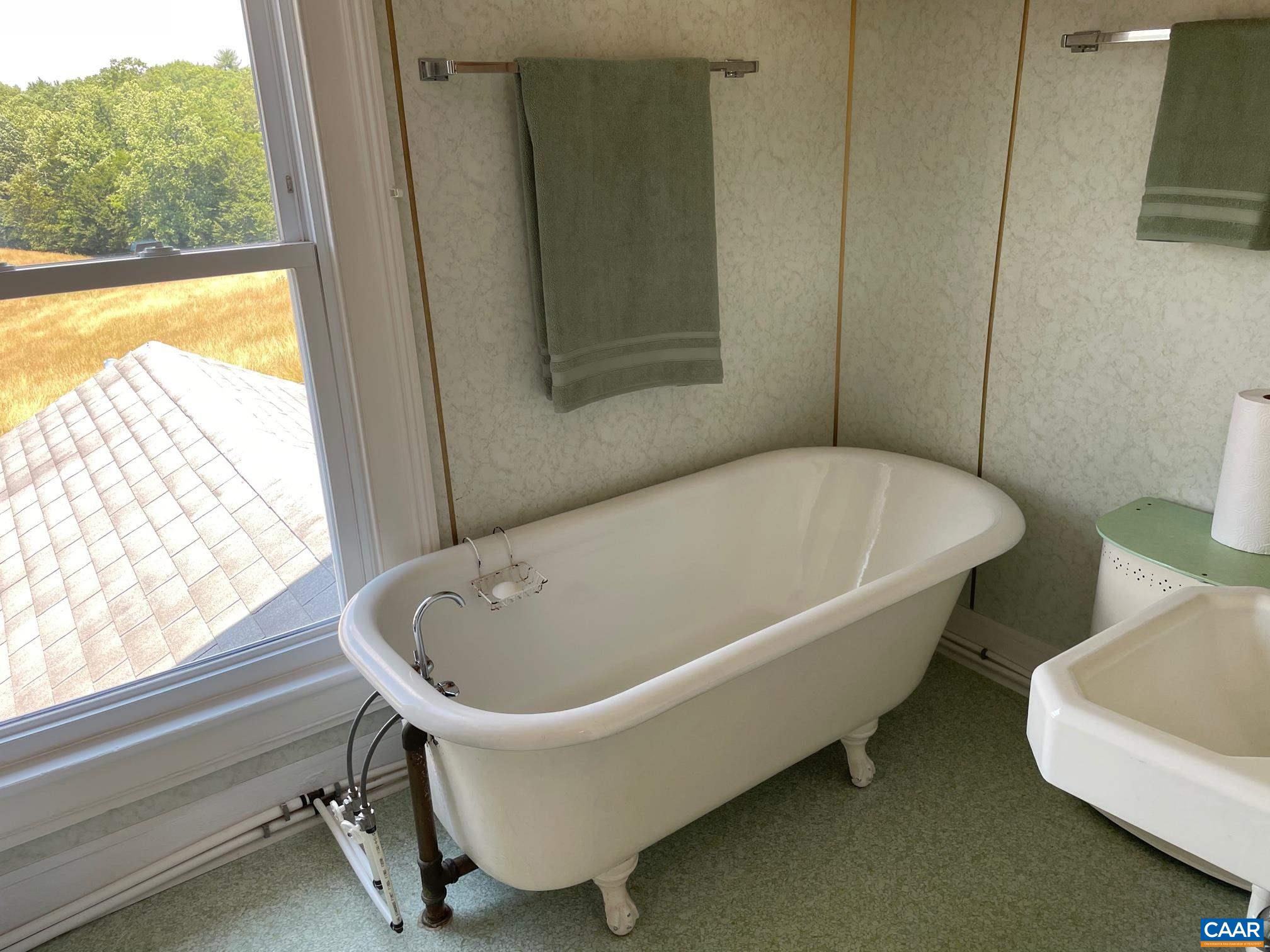 772 Poplar Spring Road Scottsville, VA 24590 - Photo 38 of 74 a white bath tub sitting in a bathroom next to a window