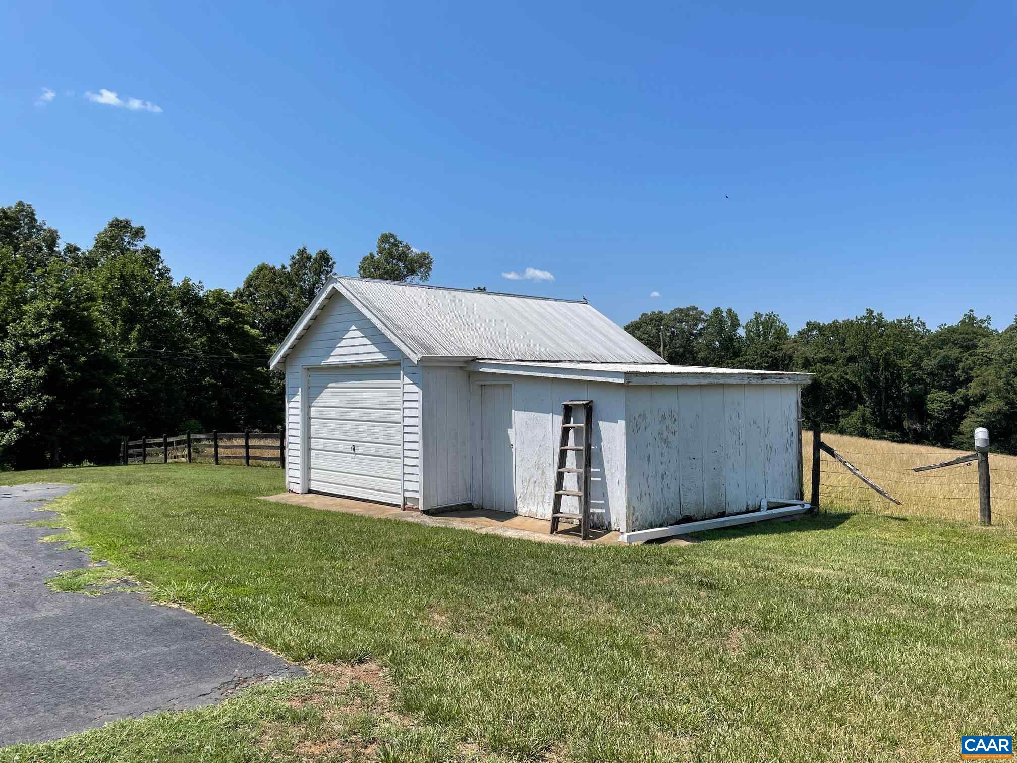772 Poplar Spring Road Scottsville, VA 24590 - Photo 45 of 74 a view of a backyard with barn plants and large trees