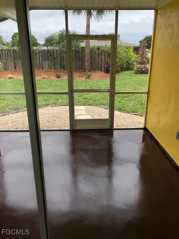 a view of empty room with wooden floor and windows