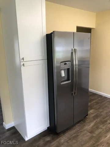 a metallic refrigerator freezer sitting in a kitchen