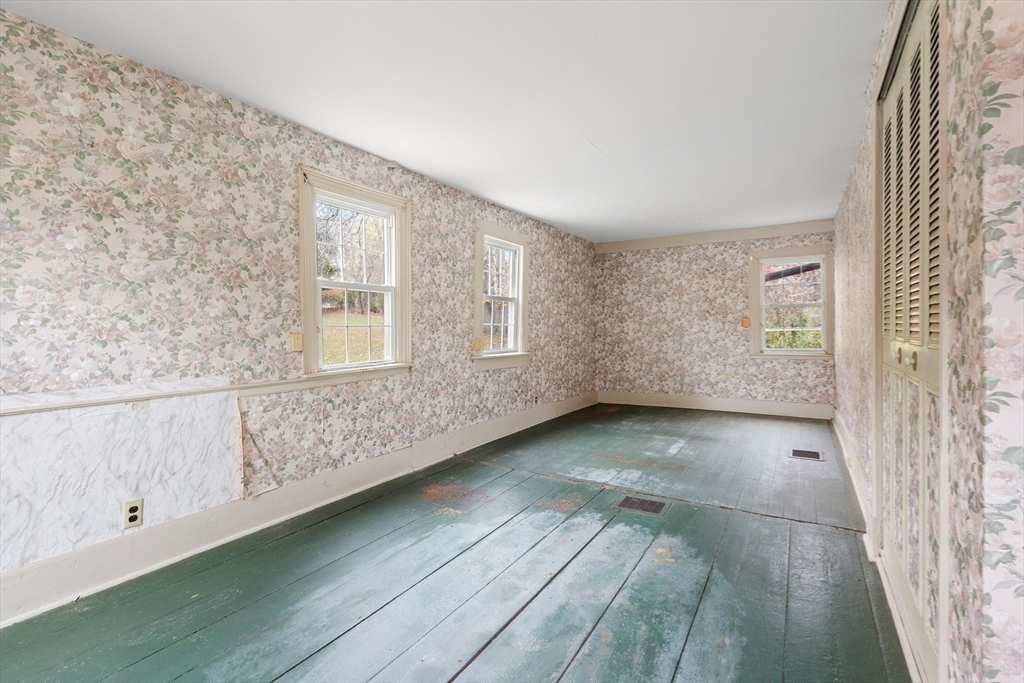 359 Kenoza Street Haverhill, MA 01830 - Photo 11 of 37 a view of an empty room with wooden floor and a window