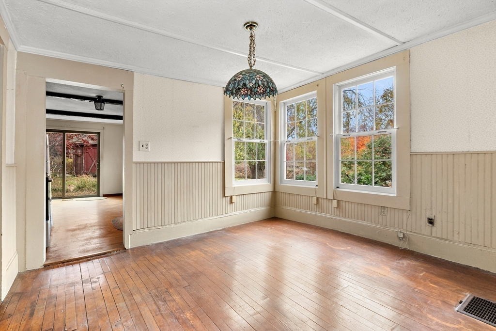 359 Kenoza Street Haverhill, MA 01830 - Photo 14 of 37 a view of an empty room with a window and wooden floor
