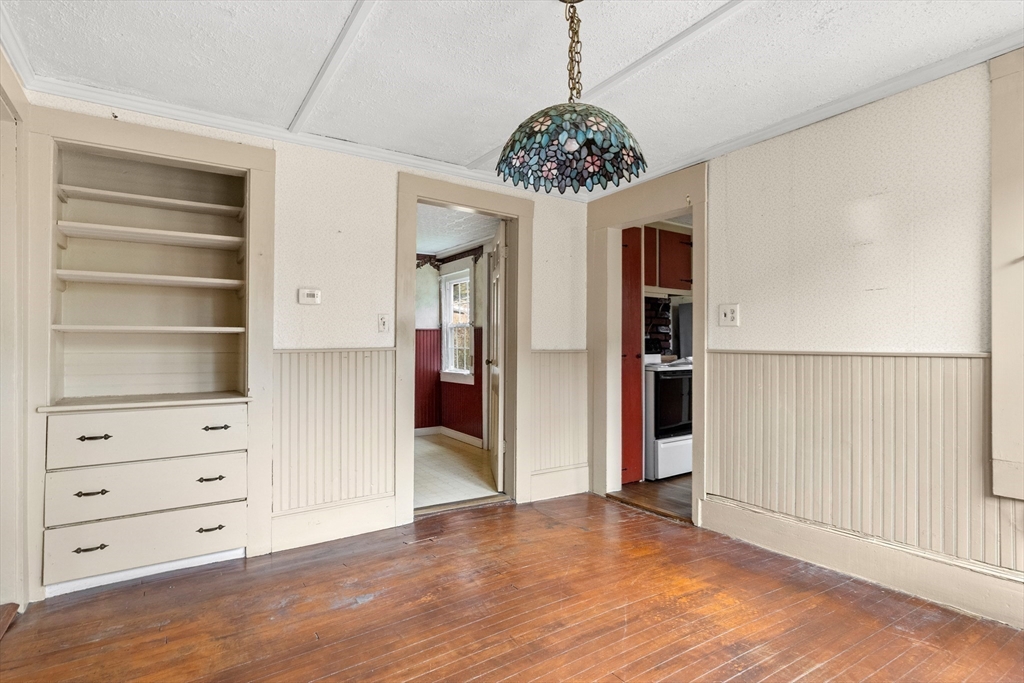 359 Kenoza Street Haverhill, MA 01830 - Photo 15 of 37 wooden floor in an empty room with a chandelier