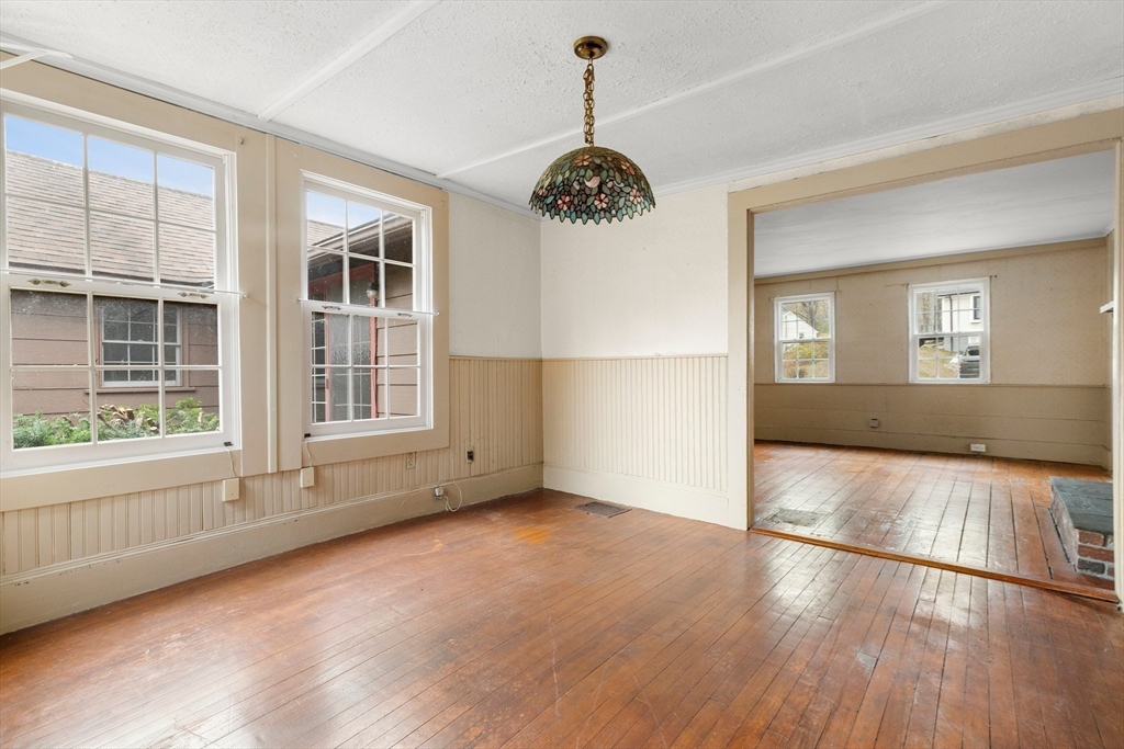 359 Kenoza Street Haverhill, MA 01830 - Photo 16 of 37 a view of an empty room with wooden floor and a window