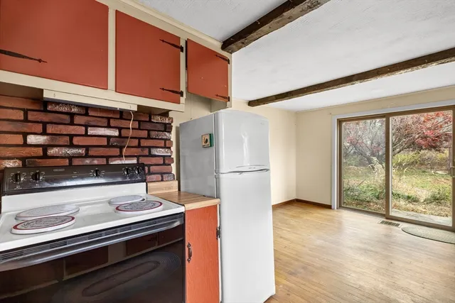 a kitchen with refrigerator and window