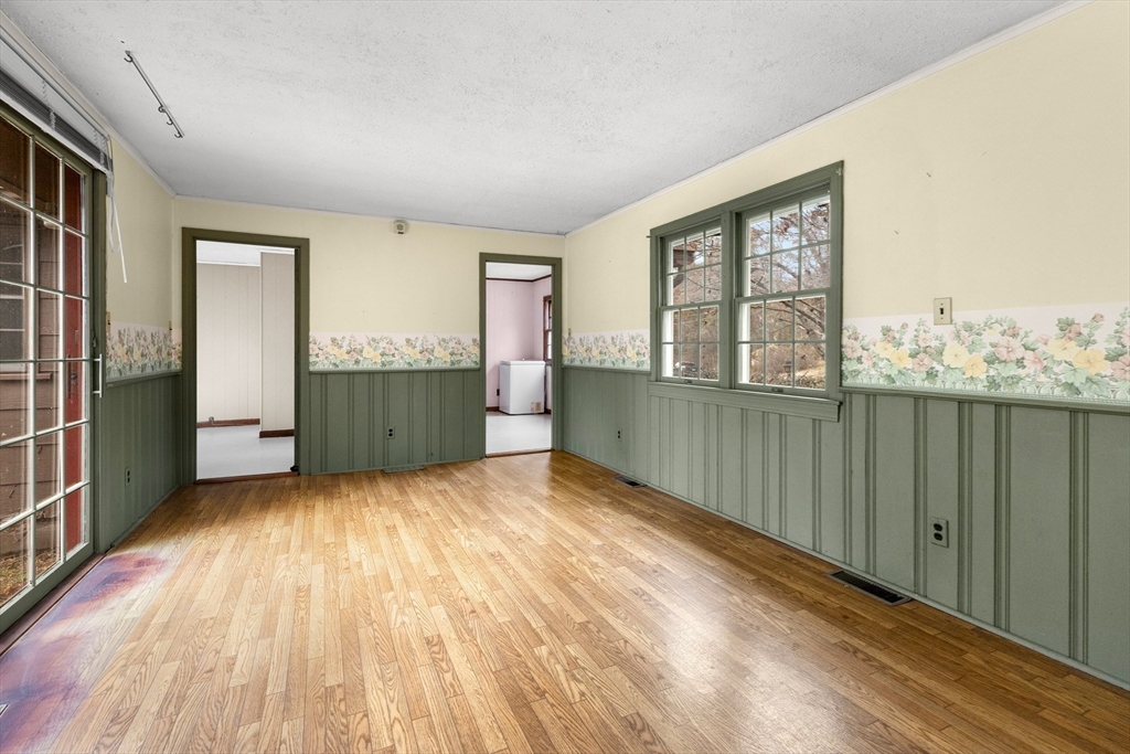359 Kenoza Street Haverhill, MA 01830 - Photo 23 of 37 an empty room with wooden floor and windows