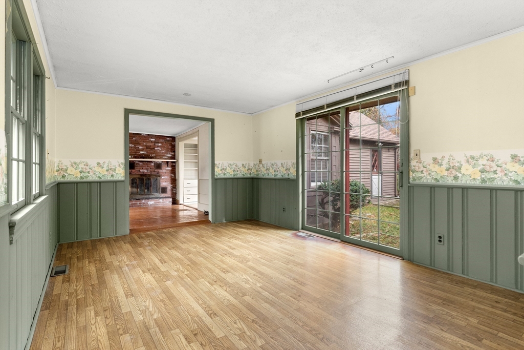 359 Kenoza Street Haverhill, MA 01830 - Photo 25 of 37 an empty room with floor to ceiling window and wooden floor