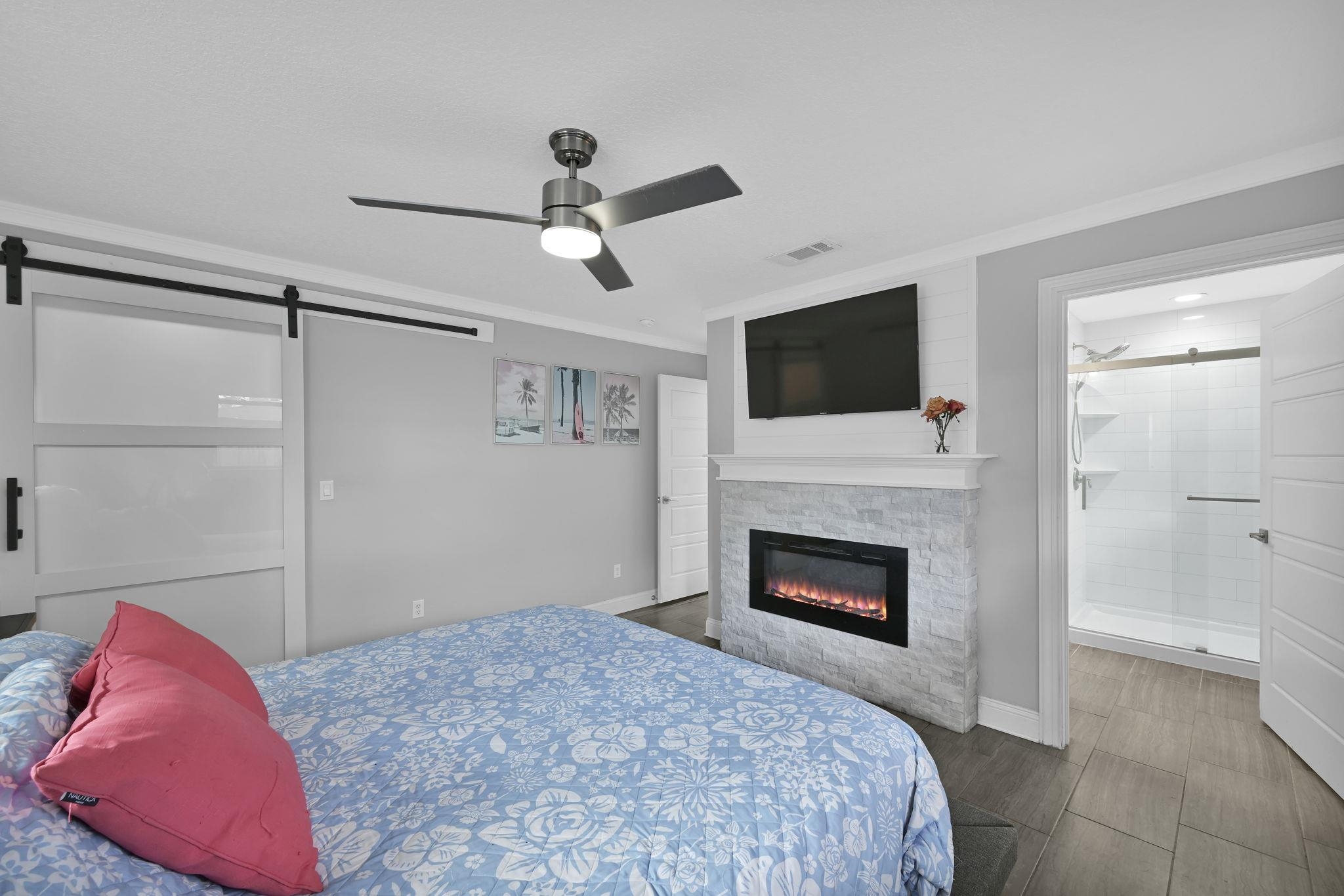 314 Arpieka Avenue St. Augustine, FL 32080 - Photo 14 of 28 a bedroom with a bed and a fireplace