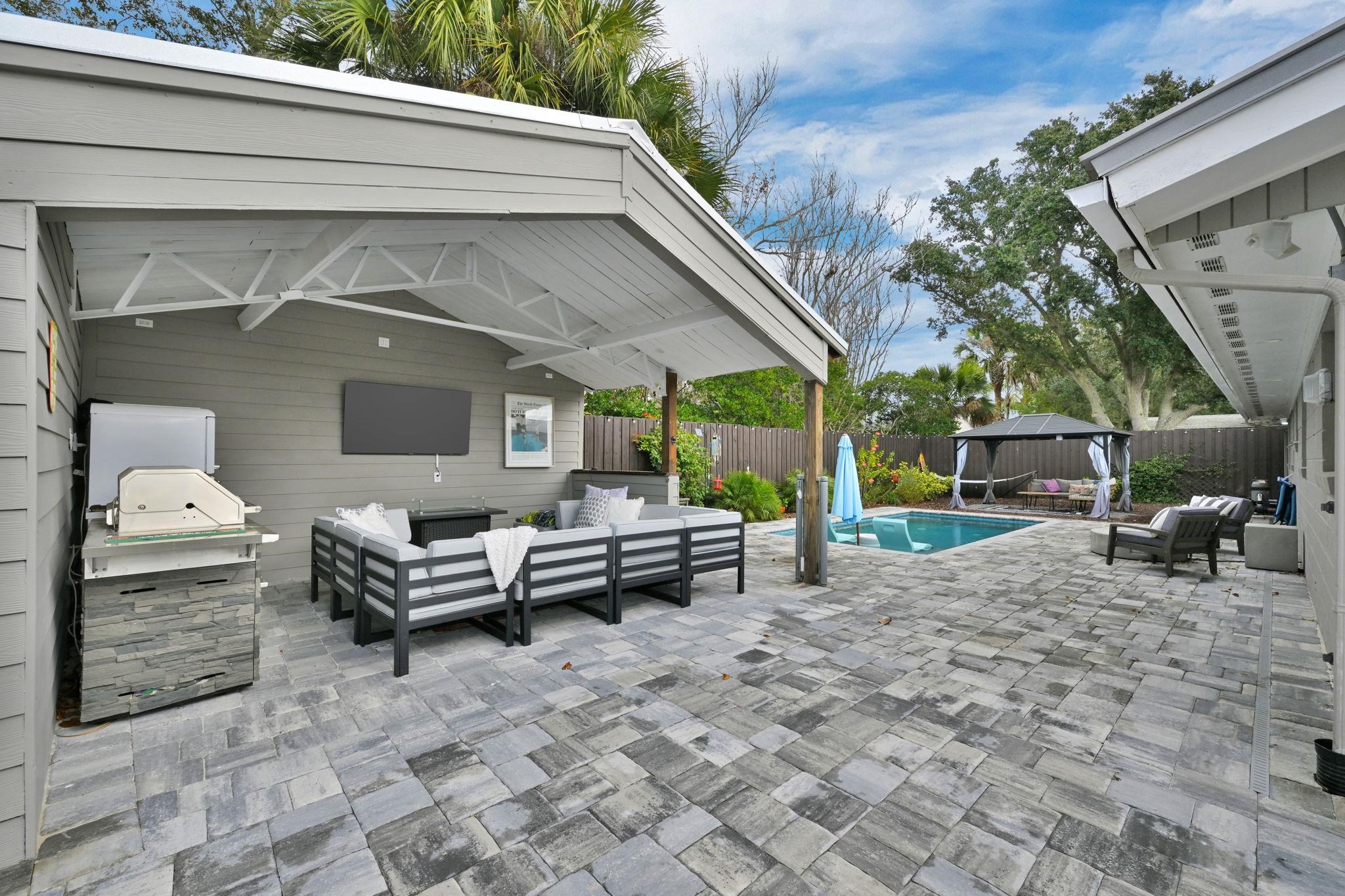 314 Arpieka Avenue St. Augustine, FL 32080 - Photo 20 of 28 a backyard of a house with barbeque oven table and chairs