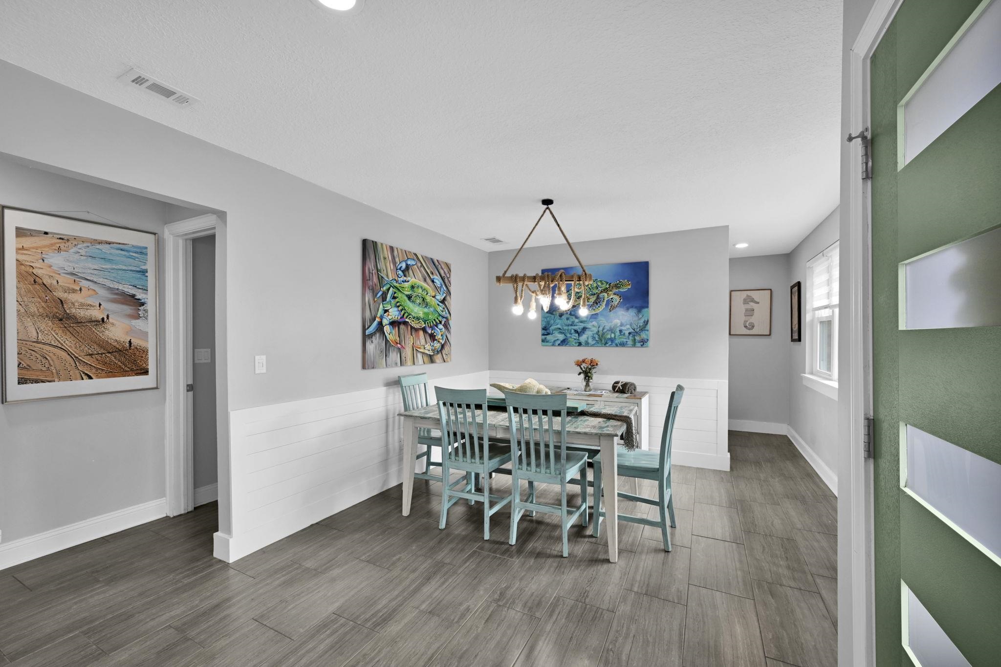 314 Arpieka Avenue St. Augustine, FL 32080 - Photo 6 of 28 a view of a dining room with furniture a chandelier and wooden floor