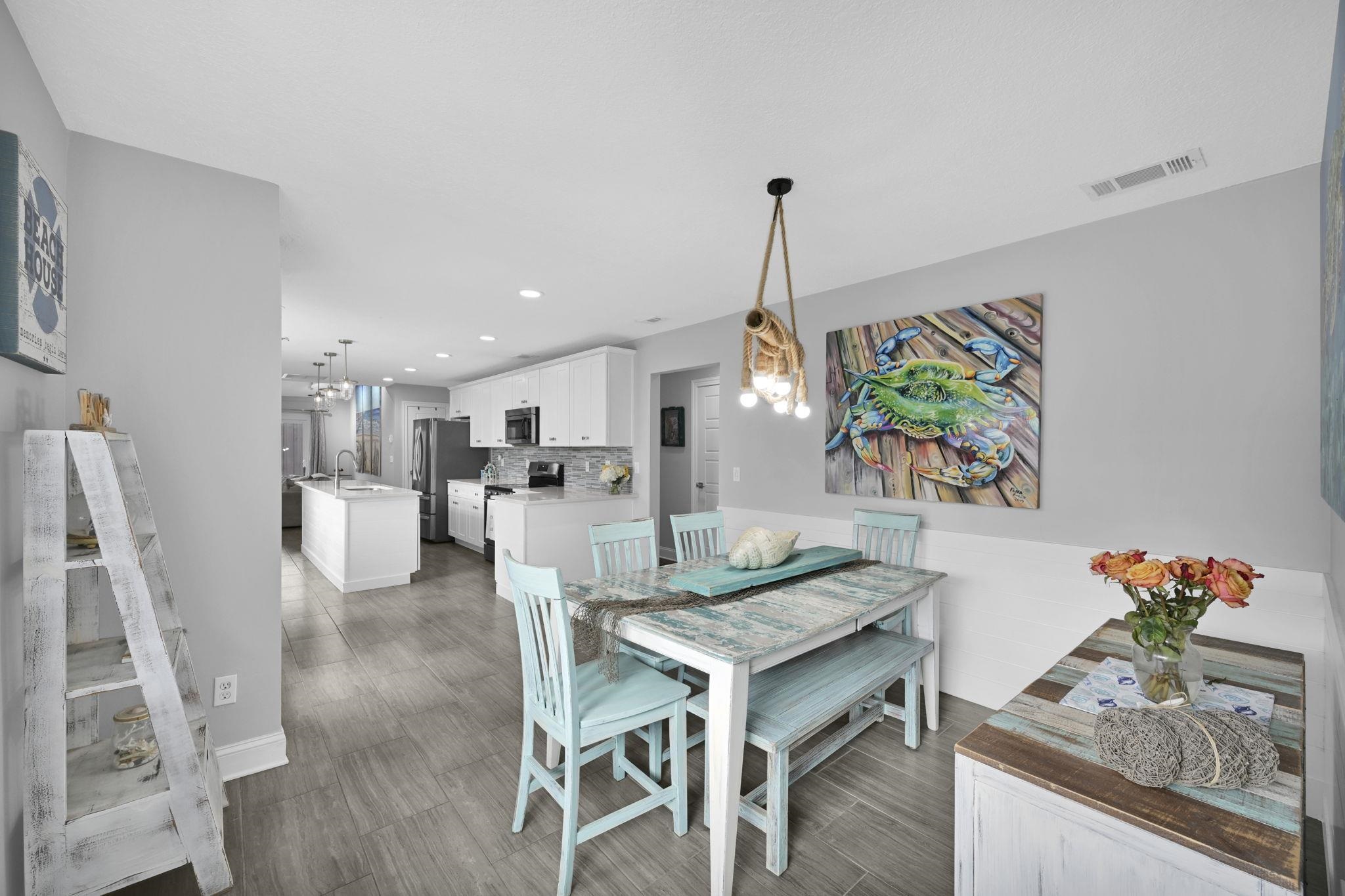 314 Arpieka Avenue St. Augustine, FL 32080 - Photo 8 of 28 a view of a dining room and furniture wooden floor kitchen and a chandelier